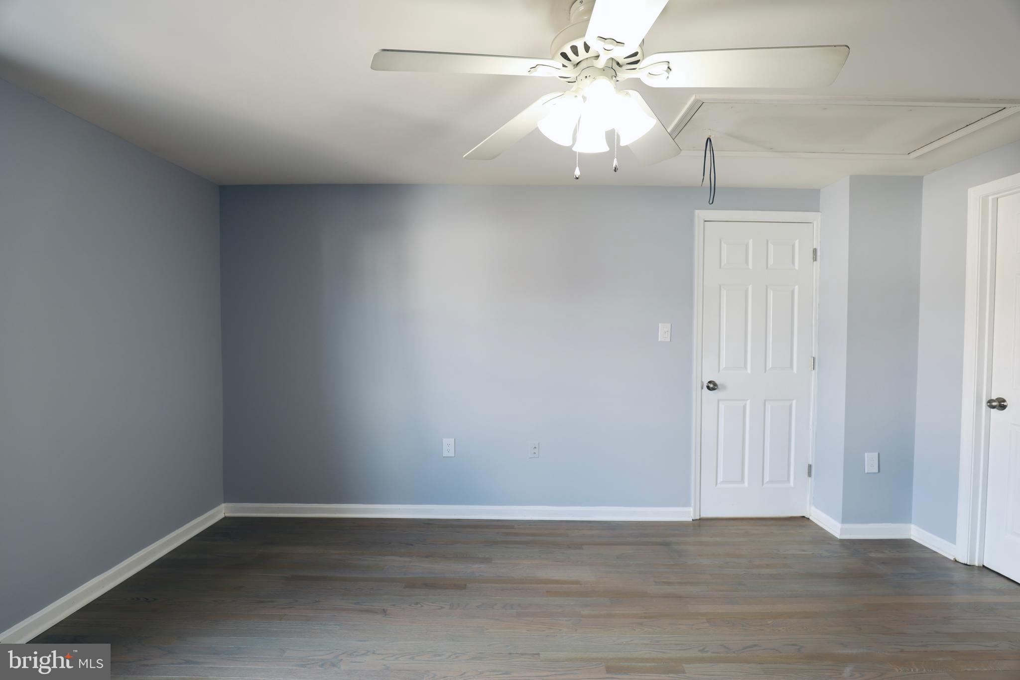 4393 Pembrook Village Drive, Unit 84 Alexandria, VA 22309 - Photo 28 of 38 an empty room with a ceiling fan and wooden floor
