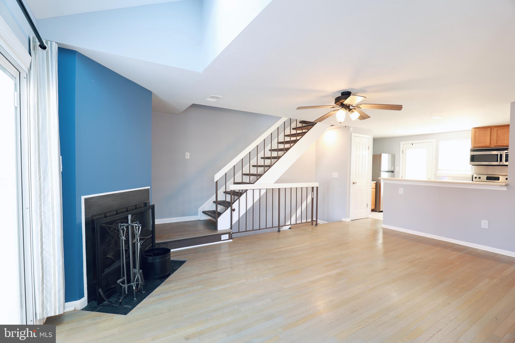 4393 Pembrook Village Drive, Unit 84 Alexandria, VA 22309 - Photo 6 of 38 a view of a livingroom with wooden floor and stairs
