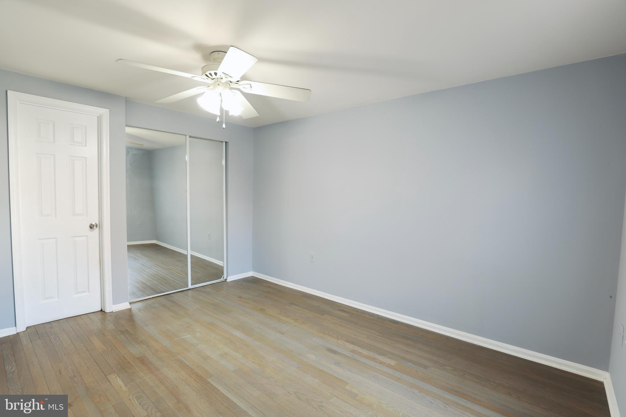 4393 Pembrook Village Drive, Unit 84 Alexandria, VA 22309 - Photo 8 of 38 an empty room with wooden floor and fan