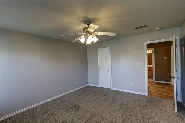 a view of a livingroom with a ceiling fan and window