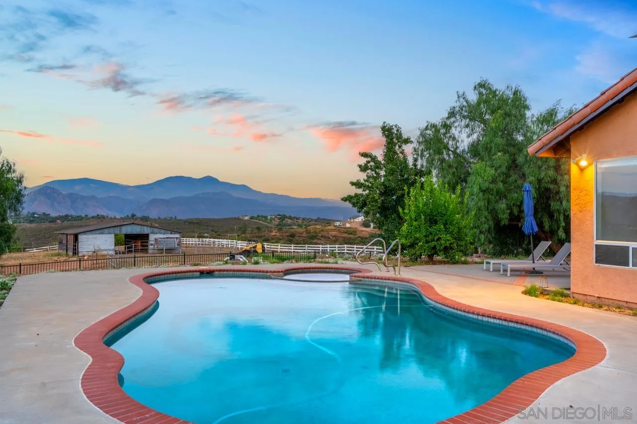 15091 Chemise Creek Road Ramona, CA 92065 - Photo 22 of 74 a view of a swimming pool with a lounge chair
