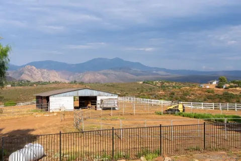 a living room with furniture chandelier and a large window