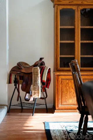 a view of a livingroom with wooden floor and a ceiling fan