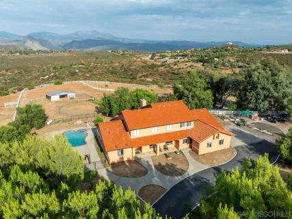 an aerial view of a house with a ocean view