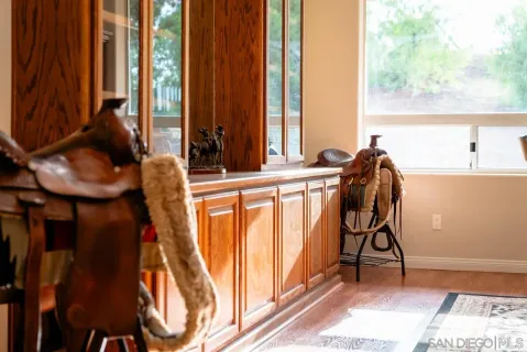 a view of a room with wooden floor staircase and a ceiling fan