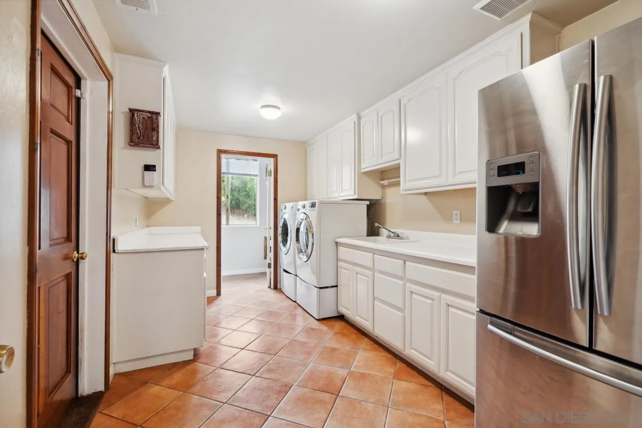 15091 Chemise Creek Road Ramona, CA 92065 - Photo 61 of 74 a kitchen with stainless steel appliances a refrigerator sink and cabinets