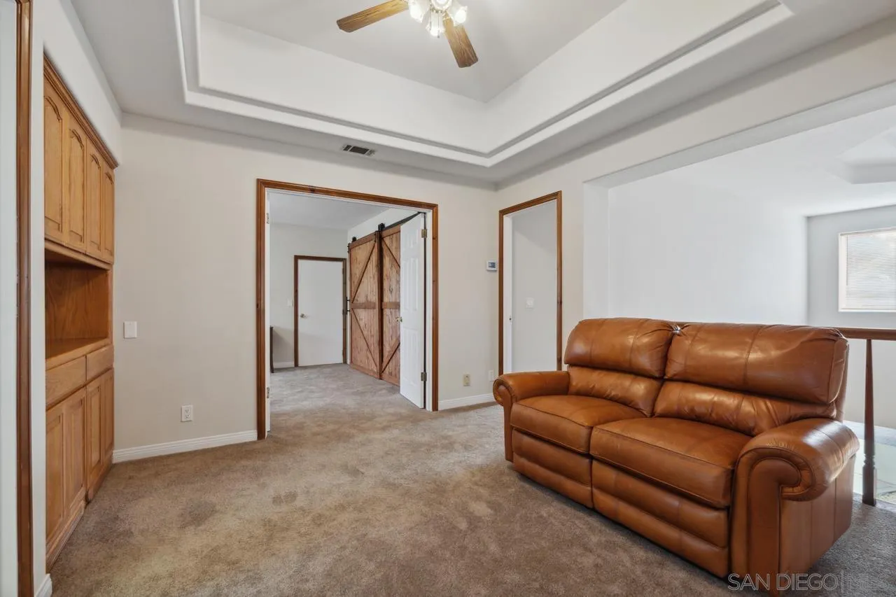 15091 Chemise Creek Road Ramona, CA 92065 - Photo 63 of 74 a living room with furniture and a ceiling fan