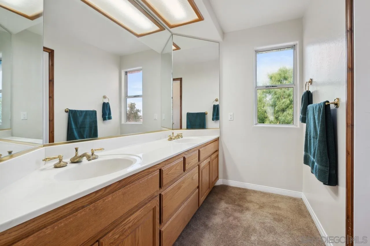 15091 Chemise Creek Road Ramona, CA 92065 - Photo 66 of 74 a bathroom with a double vanity sink and a mirror