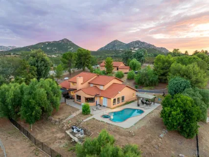 an aerial view of residential houses with outdoor space and river
