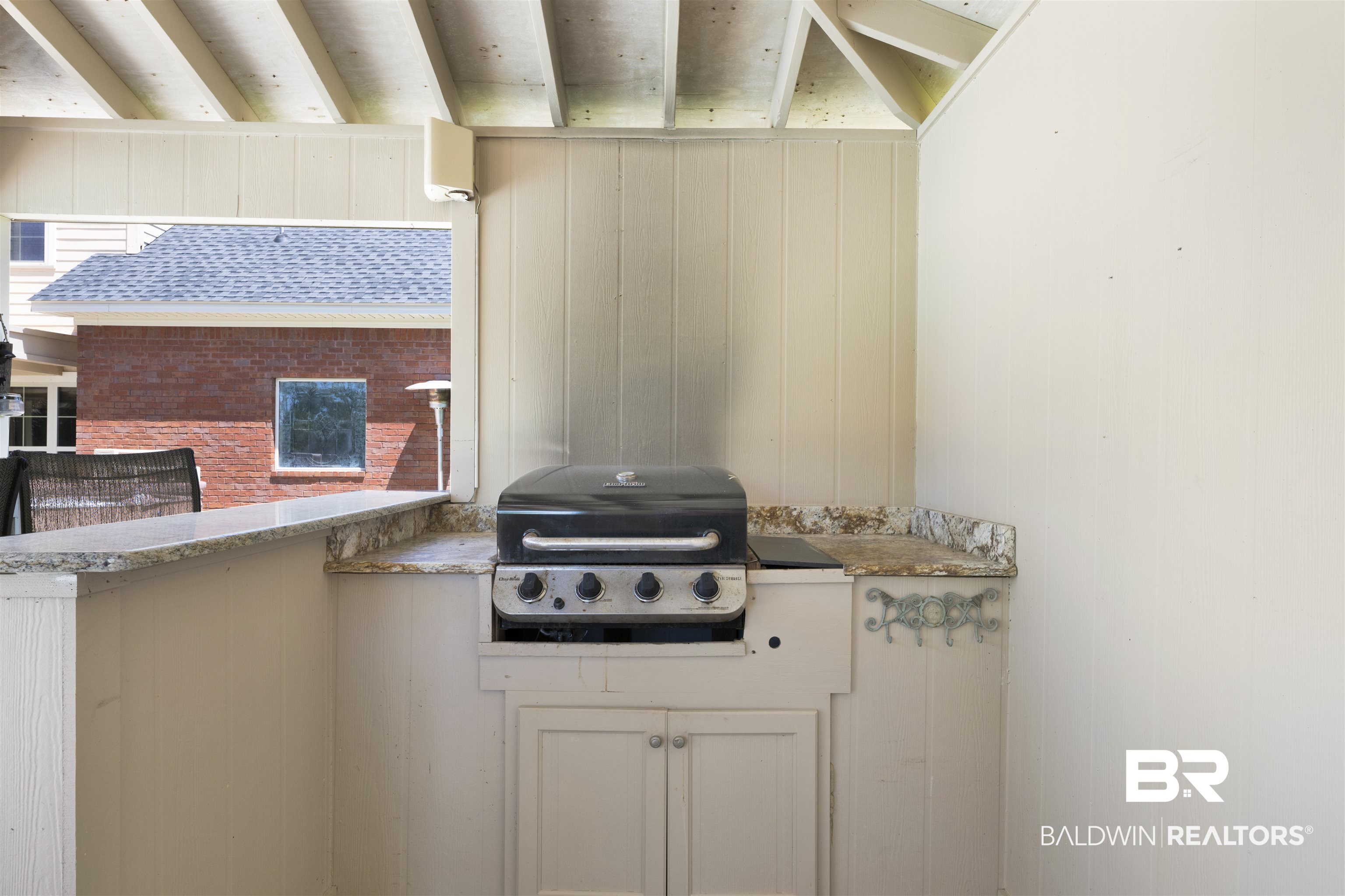 12944 Anna's Way Stapleton, AL 36578 - Photo 28 of 64 Outdoor kitchen area featuring a built-in grill, stone-finish countertops, and under-counter cabinetry