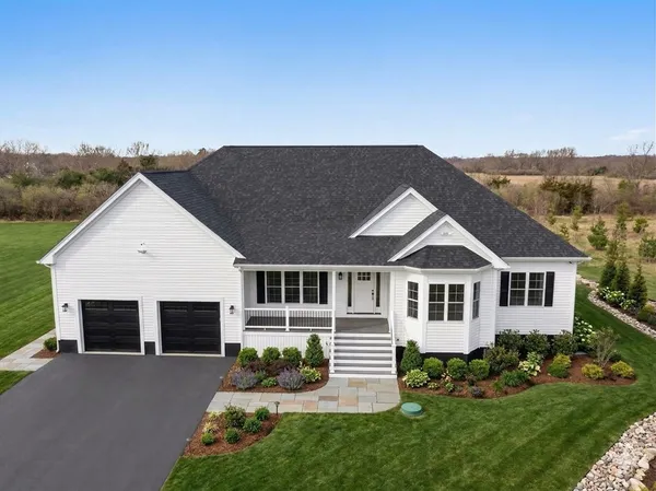 a house with green field in front of it