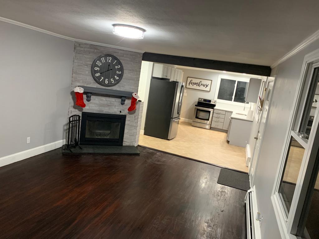 30 Dunns Pond Road Hyannis, MA 02601 - Photo 4 of 33 a view of a livingroom with furniture wooden floor and a fireplace