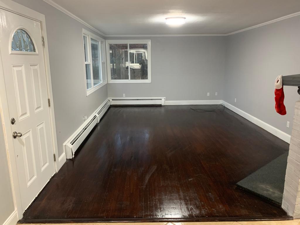 30 Dunns Pond Road Hyannis, MA 02601 - Photo 6 of 33 an empty room with wooden floor and windows