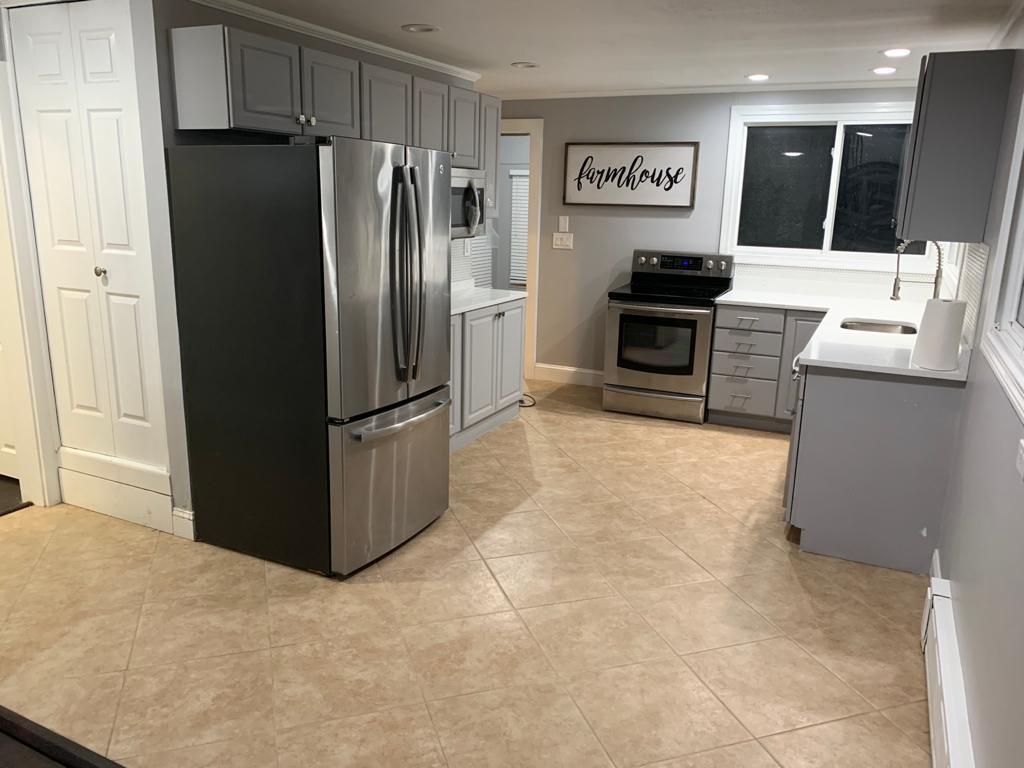 30 Dunns Pond Road Hyannis, MA 02601 - Photo 10 of 33 a kitchen with granite countertop a refrigerator and a stove top oven
