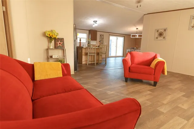 a living room with furniture or kitchen view and a wooden floor