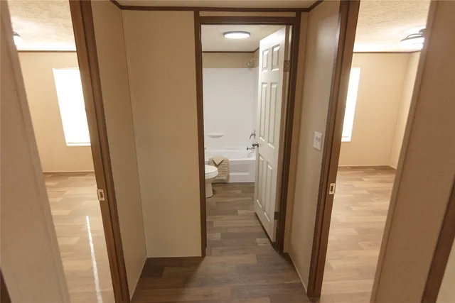 a view of a bathroom from a corridor