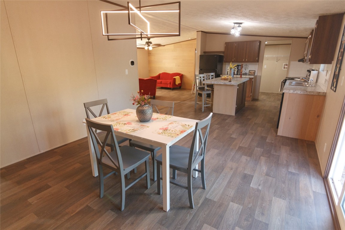 1977 Jeddo Road Rosanky, TX 78953 - Photo 10 of 30 a dining room with stainless steel appliances kitchen island granite countertop furniture wooden floor and a view of kitchen