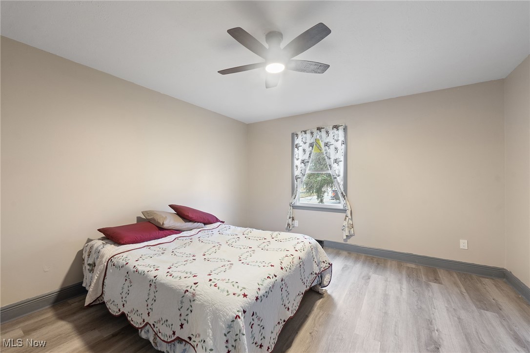 2971 Mogadore Road Akron, OH 44312 - Photo 27 of 45 Bedroom with wood-type flooring and ceiling fan