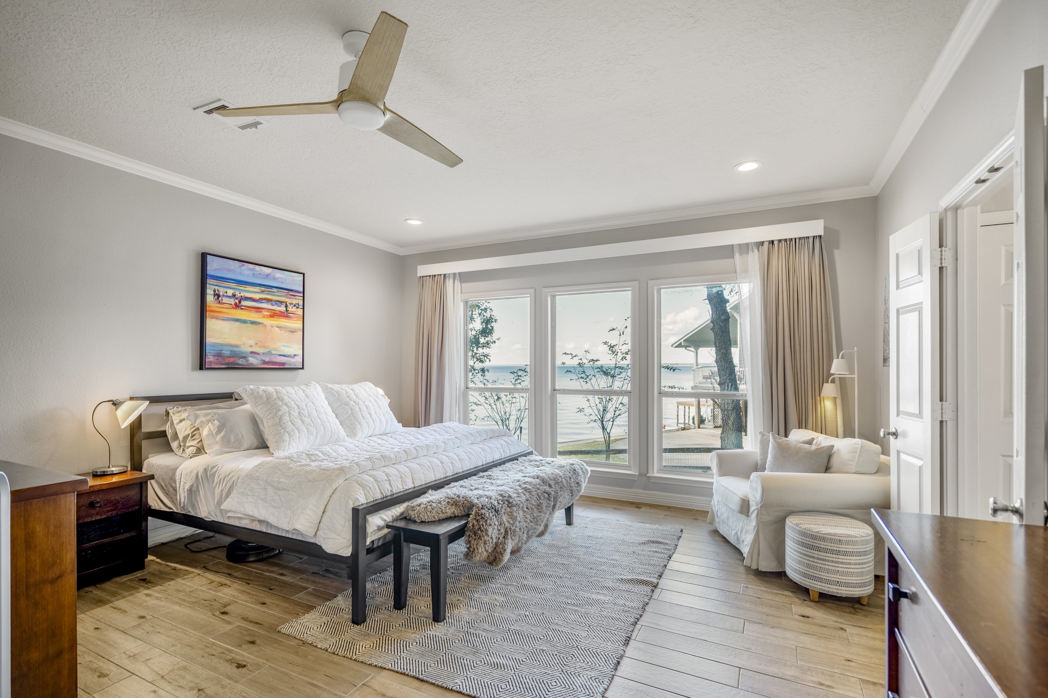 615 Inlet Drive Livingston, TX 77351 - Photo 23 of 50 The primary suite offers stunning views of the lake and tons of natural light.