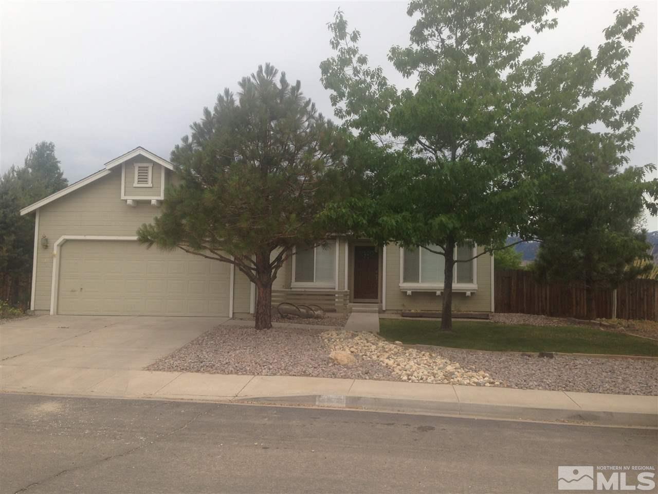 4673 Gold Strike Court Reno, NV 89521 - Photo 1 of 1 a house that has a tree in front of it