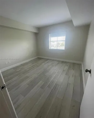 a view of a room with wooden floors and stairs