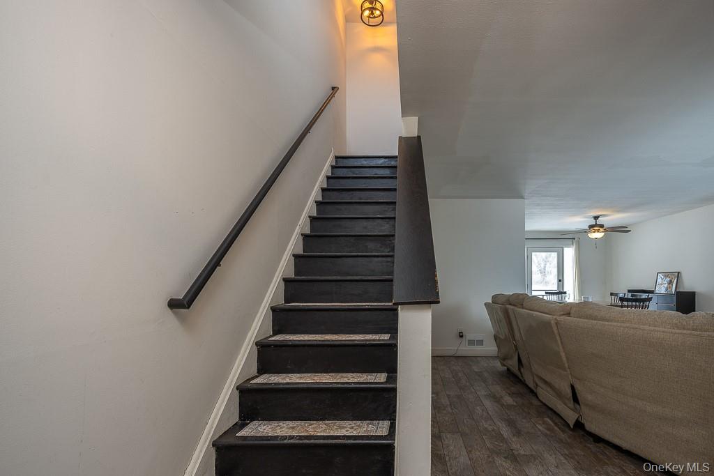 1406 Eagles Ridge Road Brewster, NY 10509 - Photo 13 of 23 a view of a hallway with stairs and wooden floor