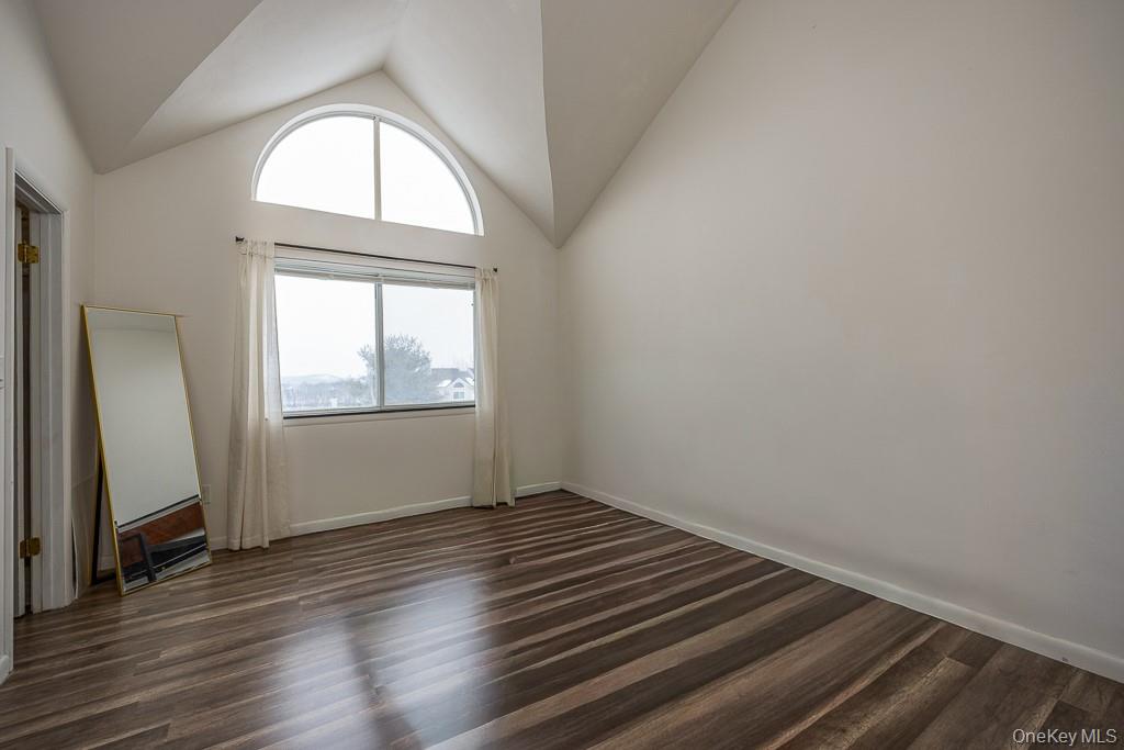 1406 Eagles Ridge Road Brewster, NY 10509 - Photo 14 of 23 an empty room with wooden floor and windows