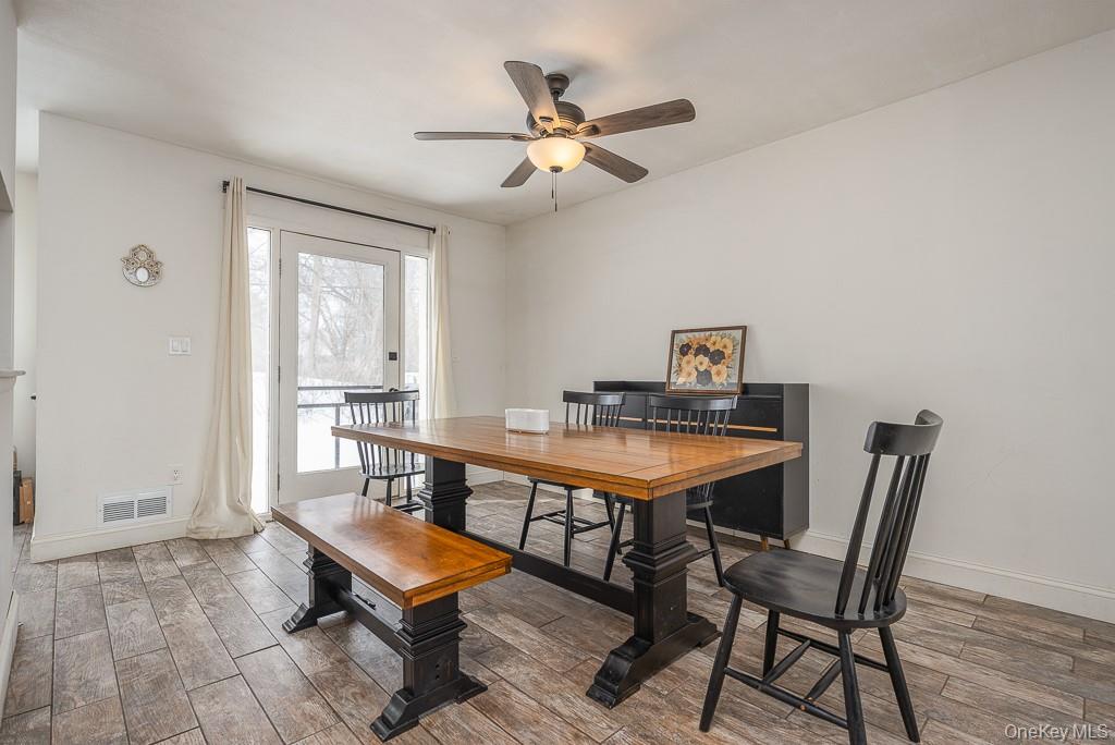 1406 Eagles Ridge Road Brewster, NY 10509 - Photo 5 of 23 a room with a table chairs and wooden floor