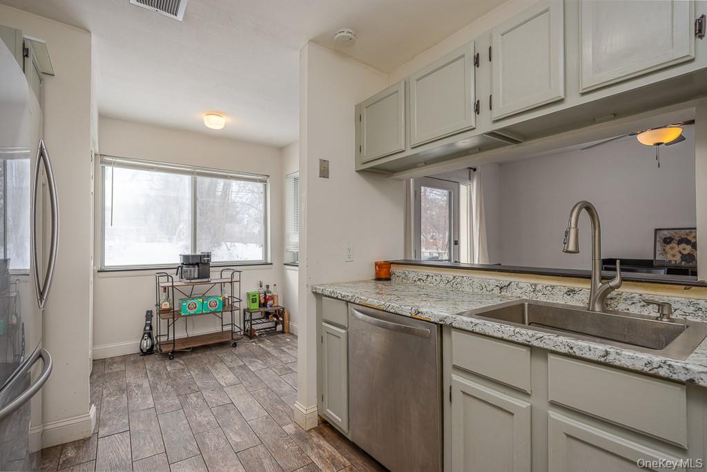 1406 Eagles Ridge Road Brewster, NY 10509 - Photo 10 of 23 a kitchen with sink cabinets and wooden floor