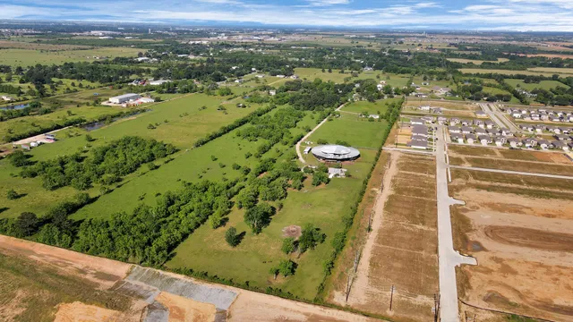 an aerial view of a residential houses with outdoor space