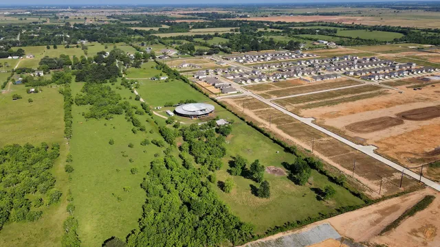 an aerial view of residential houses with outdoor space