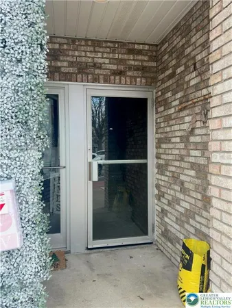 a view of a door and wooden floor