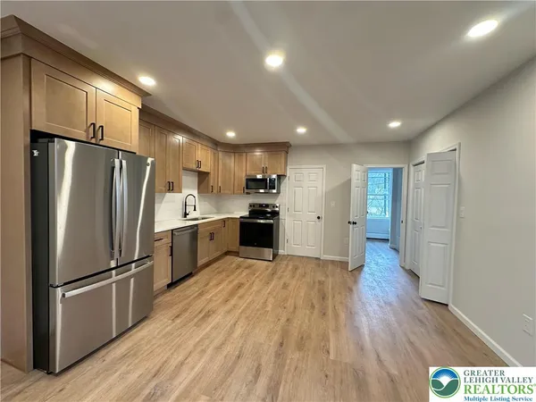 a kitchen with a refrigerator and a sink