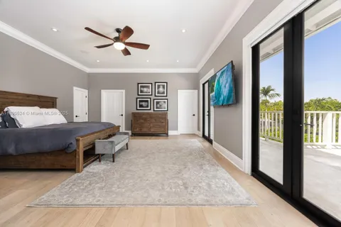 a spacious bedroom with a large bed and a chandelier