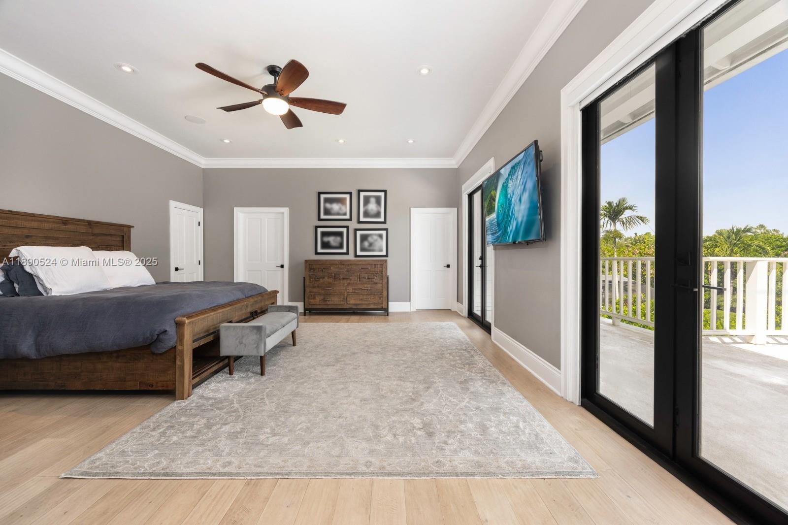 8521 Southwest 145th Street Palmetto Bay, FL 33158 - Photo 11 of 27 a spacious bedroom with a large bed and a chandelier