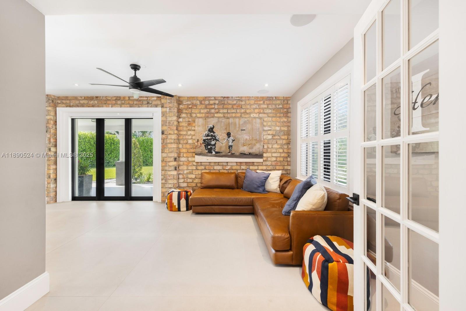 8521 Southwest 145th Street Palmetto Bay, FL 33158 - Photo 18 of 27 a living room with furniture and a large window
