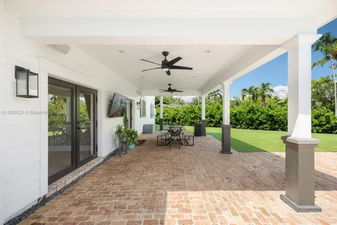 a view of a porch with furniture and a yard