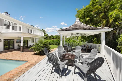 a view of a patio with couches table and chairs and potted plants