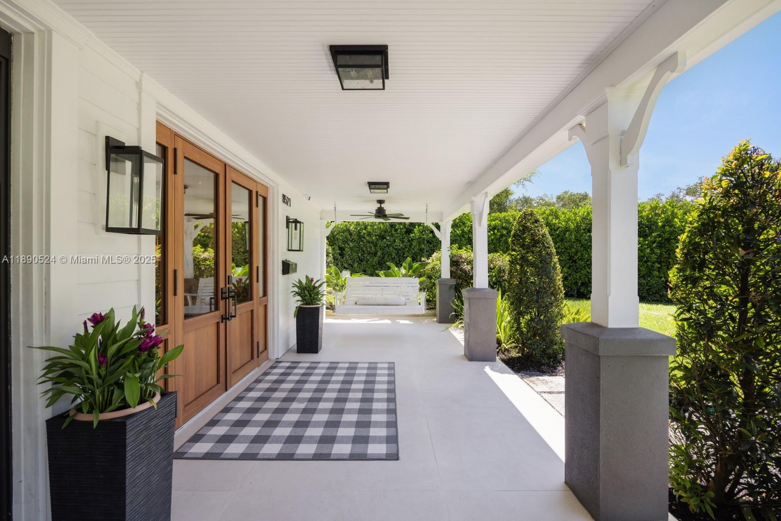8521 Southwest 145th Street Palmetto Bay, FL 33158 - Photo 4 of 27 a view of a porch with plants and garden
