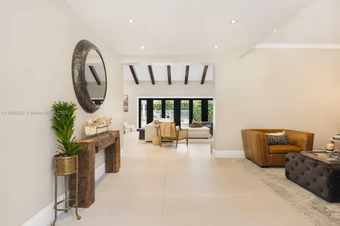 a living room with furniture a rug and a large window