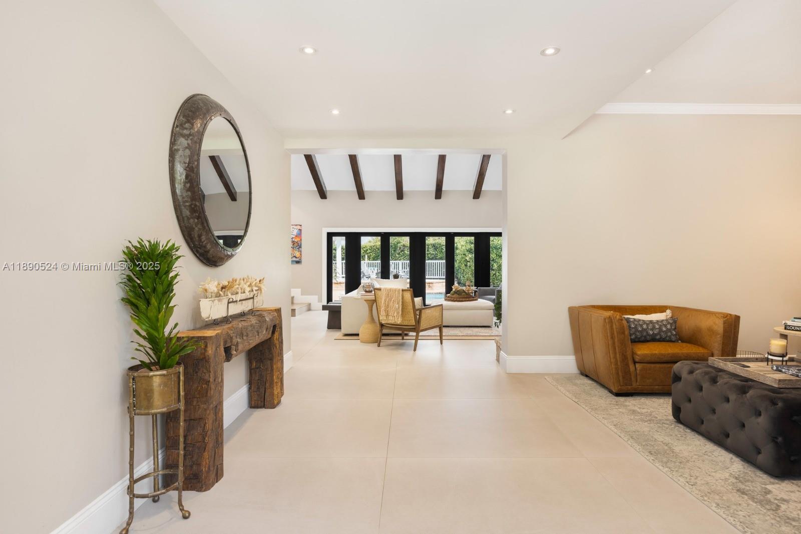 8521 Southwest 145th Street Palmetto Bay, FL 33158 - Photo 5 of 27 a living room with furniture a rug and a large window