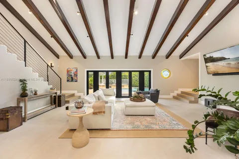 a living room with furniture and a floor to ceiling window