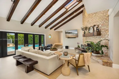 a living room with furniture and a floor to ceiling window