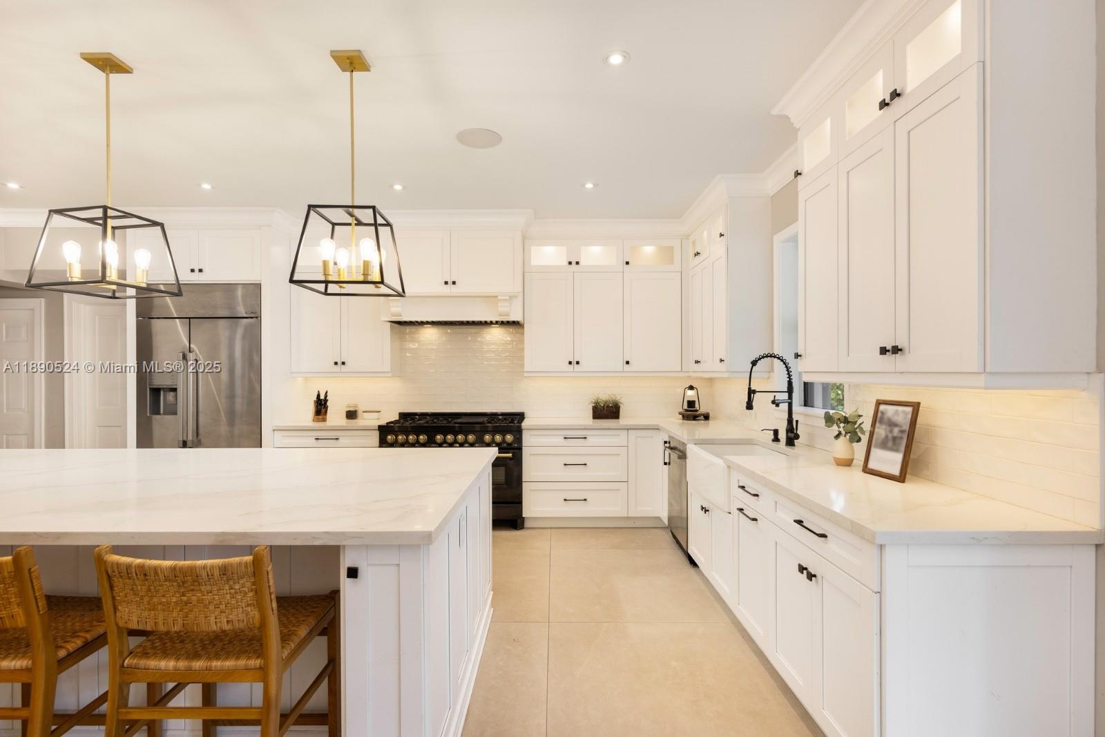 8521 Southwest 145th Street Palmetto Bay, FL 33158 - Photo 8 of 27 a kitchen with stainless steel appliances granite countertop a sink a stove and a wooden floors