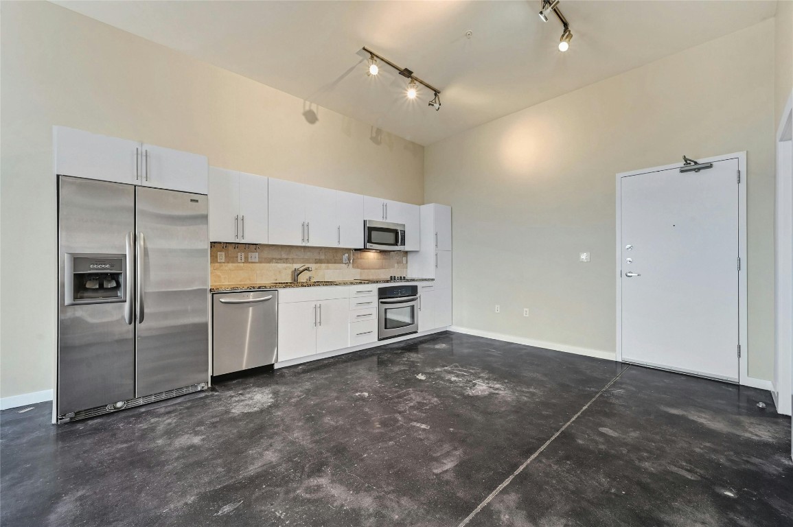 2235 East 6th Street, Unit 402 Austin, TX 78702 - Photo 30 of 30 a kitchen with cabinets and stainless steel appliances
