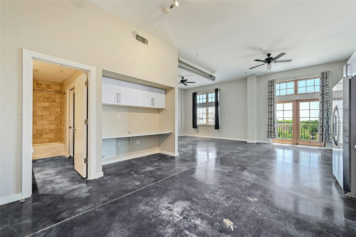 2235 East 6th Street, Unit 402 Austin, TX 78702 - Photo 28 of 30 a view of empty room with a fireplace and windows