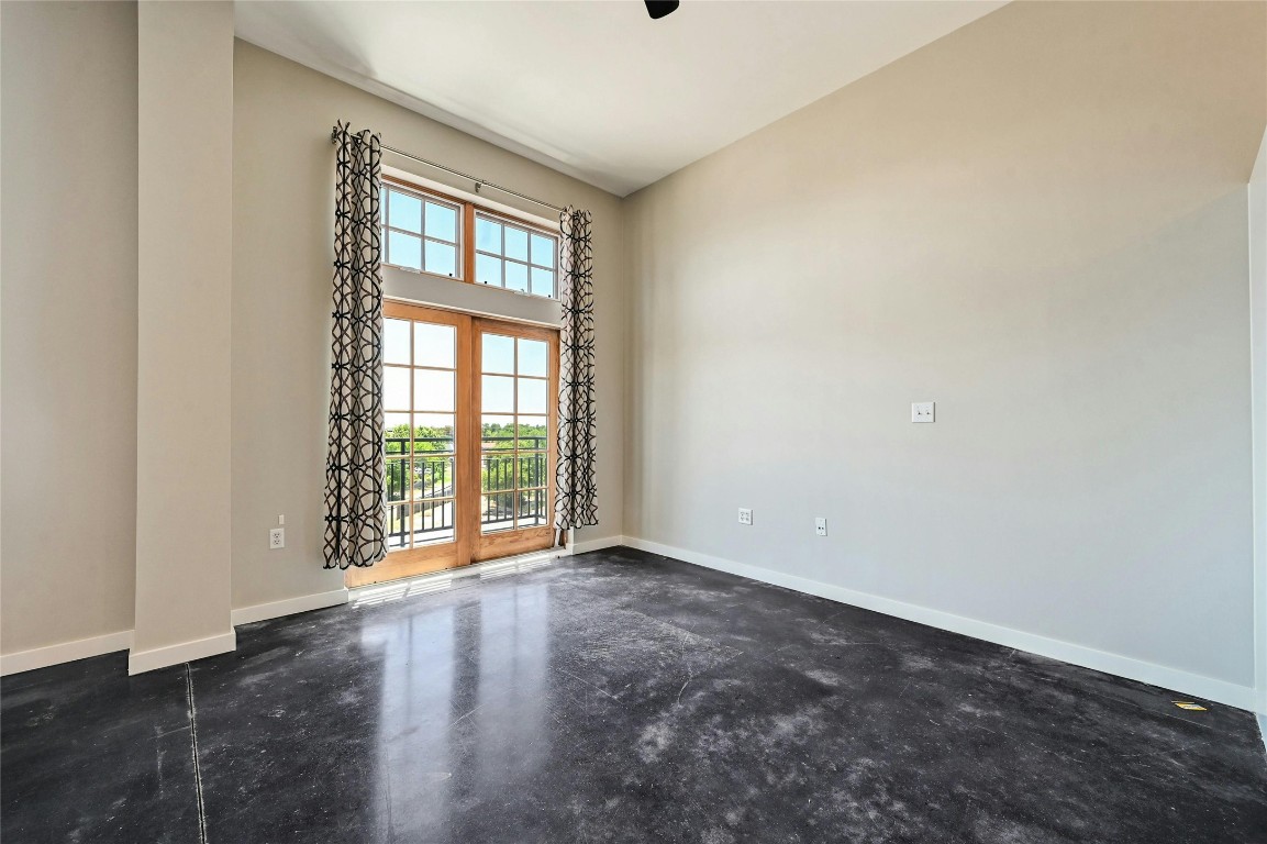 2235 East 6th Street, Unit 402 Austin, TX 78702 - Photo 29 of 30 an empty room with wooden floor and windows