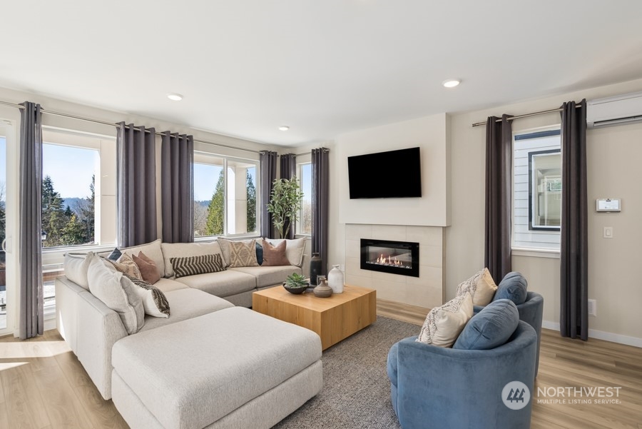 4034 Aberdeen Way Northeast, Unit 35 Renton, WA 98056 - Photo 7 of 32 a living room with furniture a fireplace and a large window