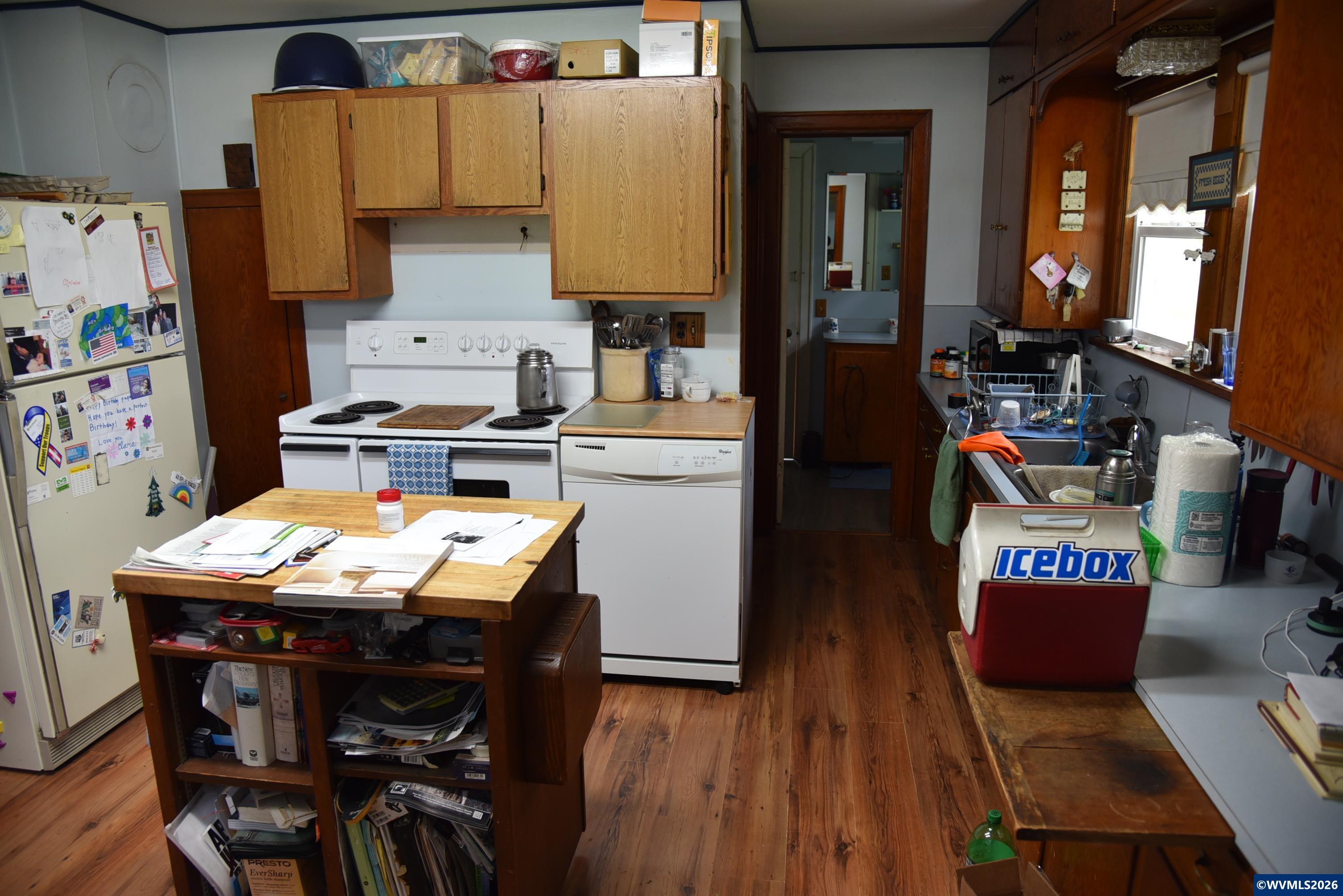 25258 Rowland Road Harrisburg, OR 97446 - Photo 24 of 24 a kitchen with stainless steel appliances granite countertop a stove top oven a dining table and chairs with wooden floor