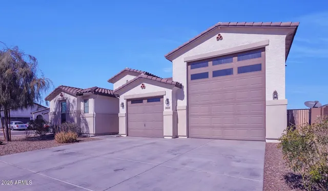 a view of a house with a yard and garage